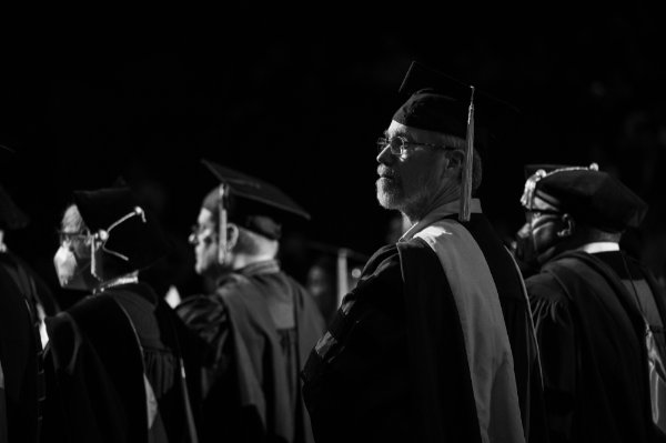  University faculty members stand during a Commencement ceremony.