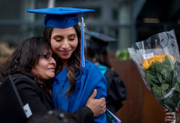  A mother tearfully embraces her daughter after she graduated from college. 