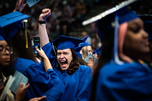  Recent college graduates celebrate during commencement. 