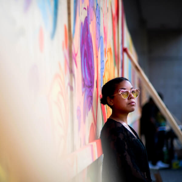 Woman standing by a mural