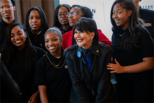 Several people smile for a group photo.