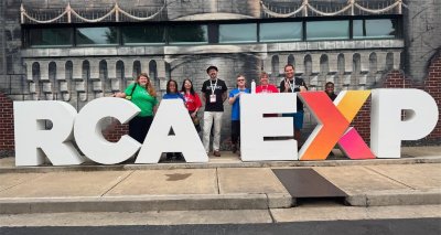 Charter school educators pose for a photo outside the Ron Clark Academy in Atlanta. 