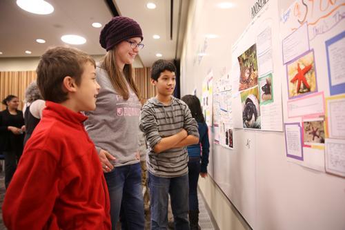 Westwood Middle School students show their projects to a Grand Valley student during a recent Challenge Scholars event. A new grant will encourage more civic engagement opportunities.