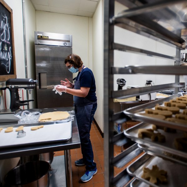 A worker at Stir It Up Bakery making cookies.