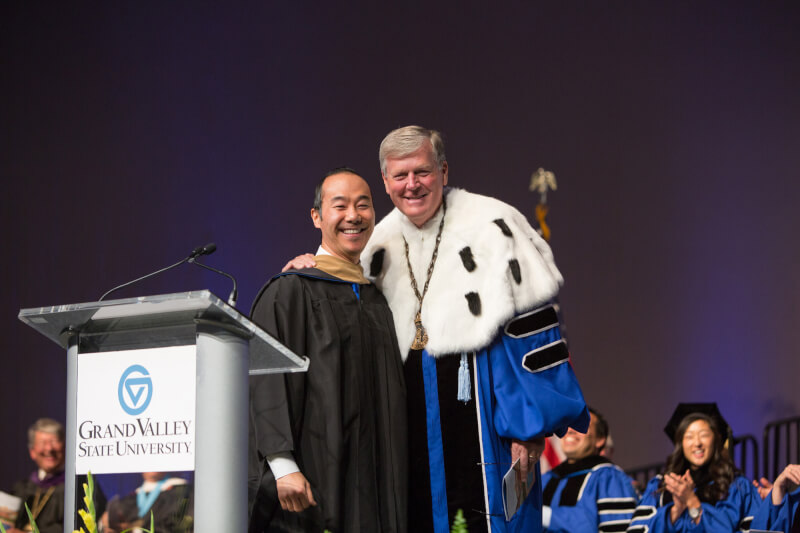 two men on stage during convocation