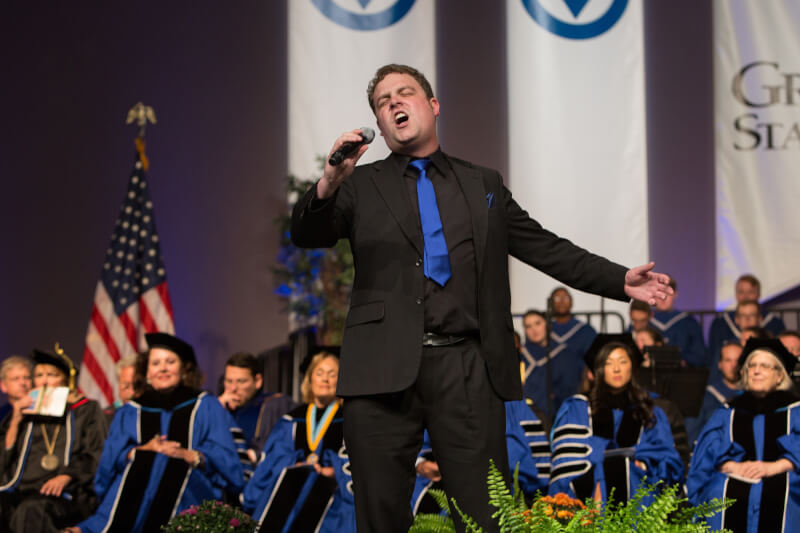 man singing on stage