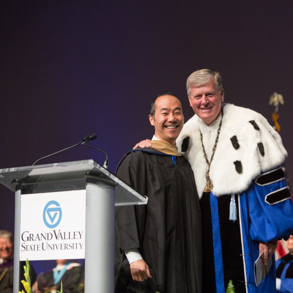 two men on stage during convocation