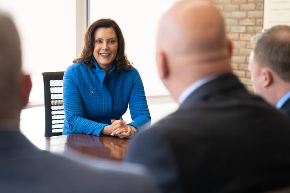 governor chatting with people at table