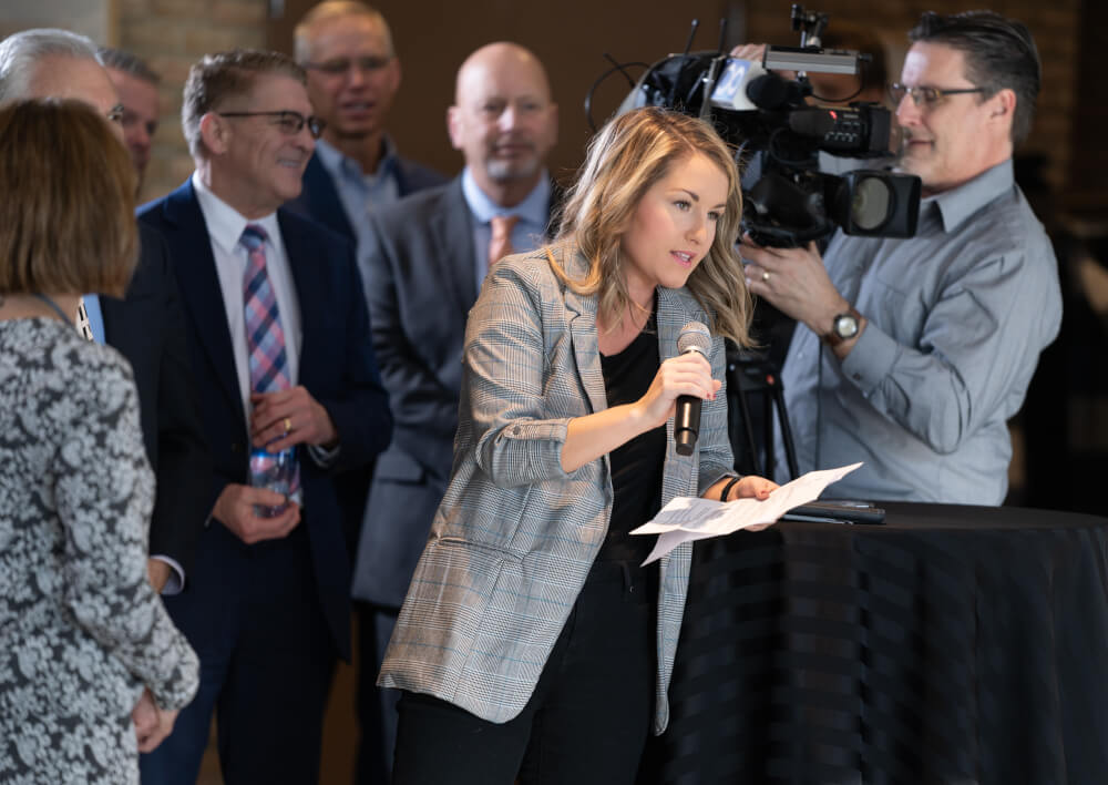 reporter asks a question with a microphone