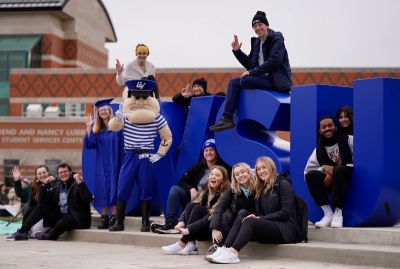 Students and Louie the Laker pose around the new GVSU Laker Letters.
