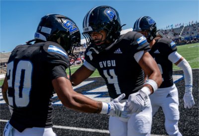 Grand Valley football players participate in a pregame warmup drill