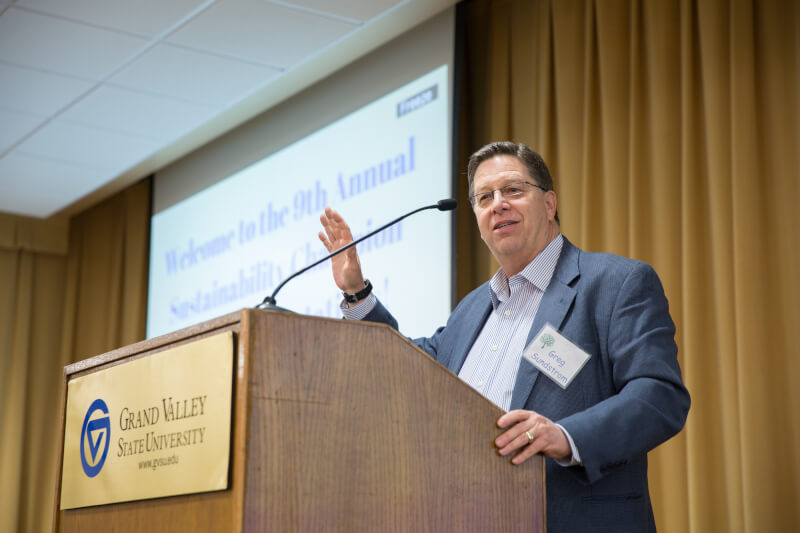 Grand Rapids City Manager and Grand Valley alumnus Greg Sundstrom congratulates award recipients.