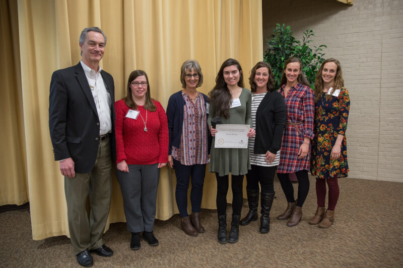 Krista Affholter, center, and Tim Thimmesch, far left, with the Feenstra family.