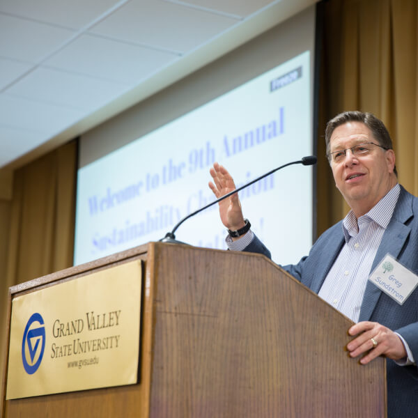 Grand Rapids City Manager and Grand Valley alumnus Greg Sundstrom congratulates award recipients.