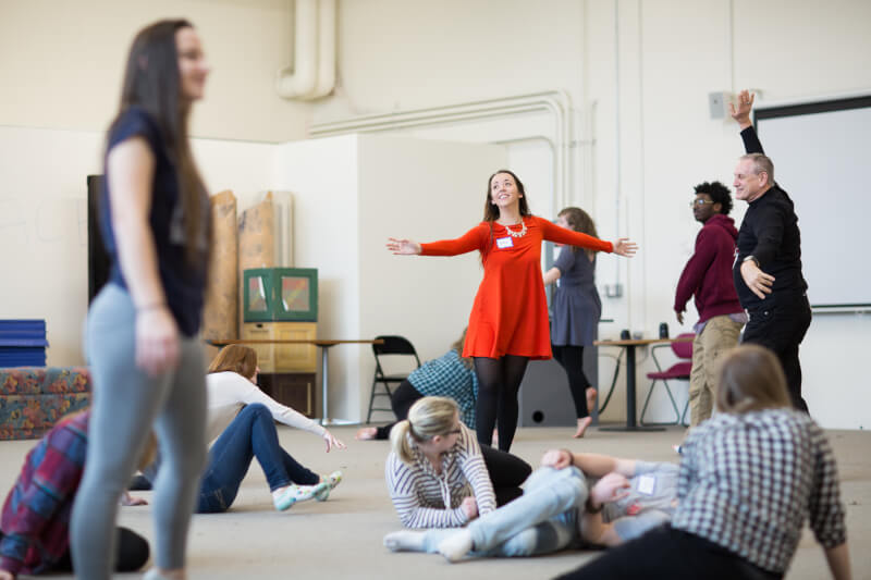 Roger Ellis, professor of theater, guiding students through theatrical movements. 
