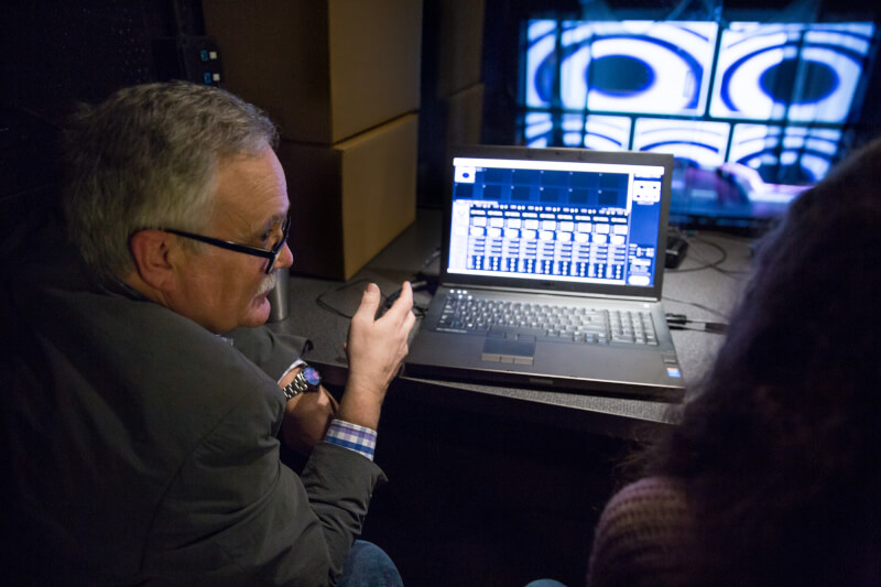Alfred Sheffield, technical theater professor, teaching students about stage lighting and projections.