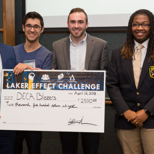 group of people holding large check