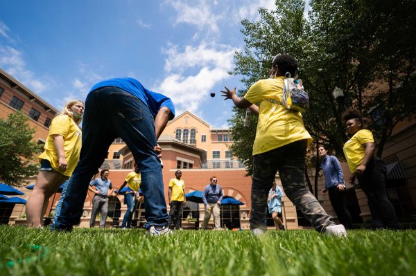 students play outdoor game with ball on Pew Grand Rapids Campus in DeVos courtyard