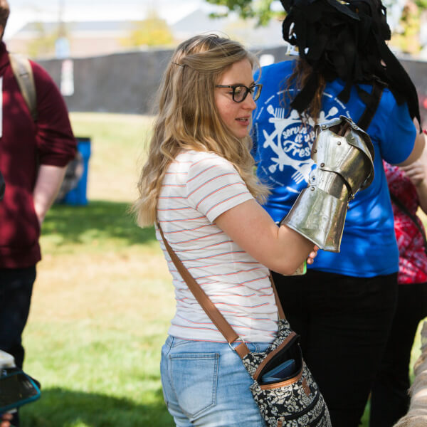 A student tries on Medieval armor during the Paleo-Olympic Games.
