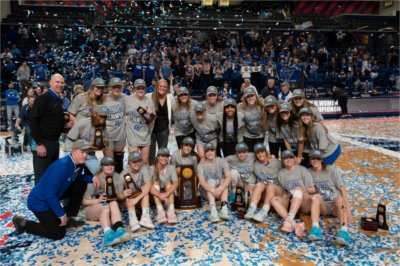 The Grand Valley women's basketball team pose for a photo with the NCAA national championship trophy following its win in the 2025 national title game 
