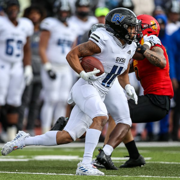 Grand Valley football player runs with the football
