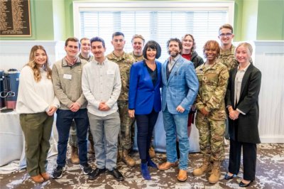 President Philomena V. Mantella and guest speaker Jason Redman pose for a photo with members of GVSU's ROTC.