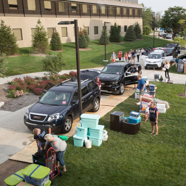 Students, faculty and staff members move items into a Grand Valley residence hall.