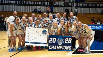 Grand Valley's women's basketball team gathers for a photo to celebrate its GLIAC Tournament championship.