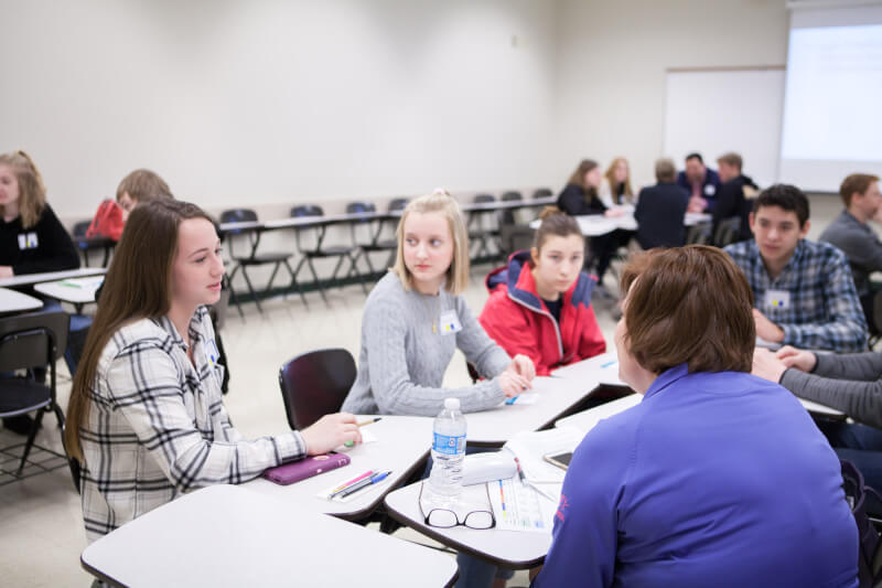 people talking around desks