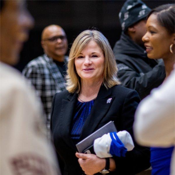 Grand Valley Director of Athletics Keri Becker talks with supporters during the news conference introducing Cornell Mann as the new men's basketball coach.