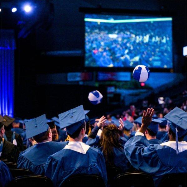 As the Commencement ceremony comes to a close, graduates pass around small beach balls while waiting to be ushered out of the stadium.