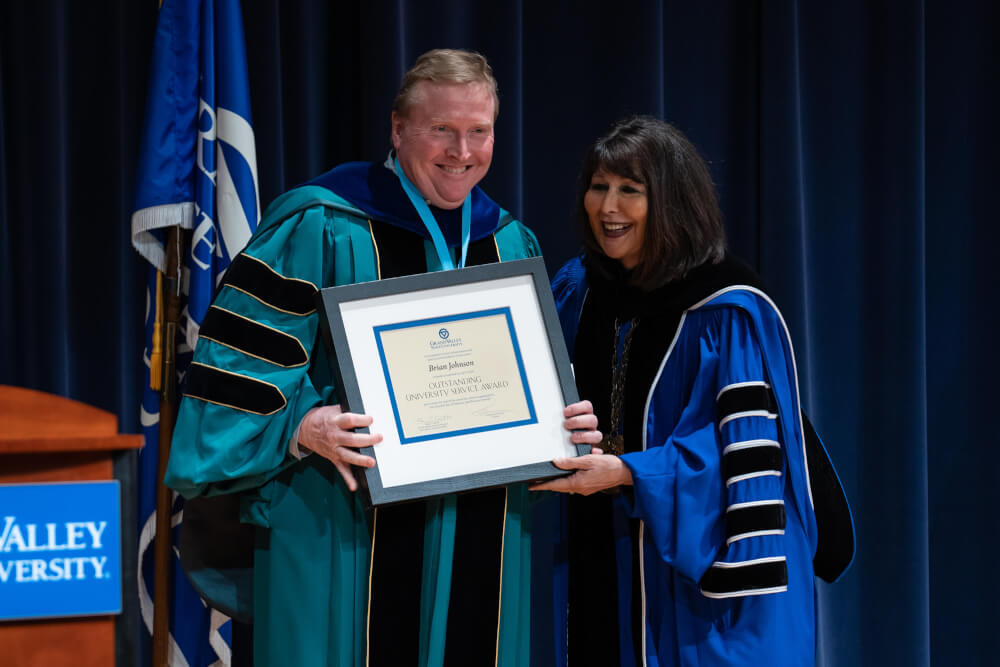man holding plaque with President Mantella