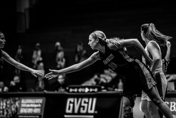 Laker Emily Spitzley gives encouragement to a teammate on the floor of a basketball game