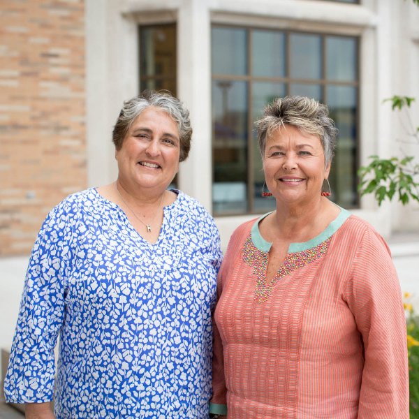 from left are Shelley Padnos and Carol Sarosik standing outside a campus building