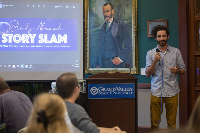 man with microphone talking to audience