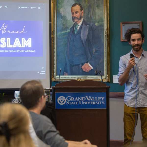 man with microphone talking to audience