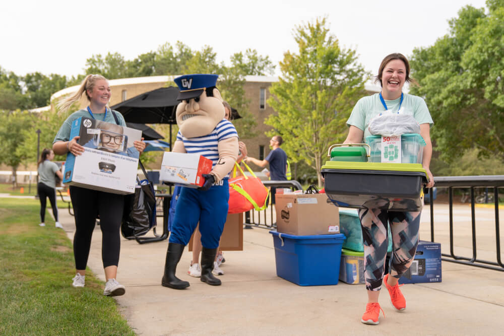 Louie the Laker helps students move in to a GVSU living center.