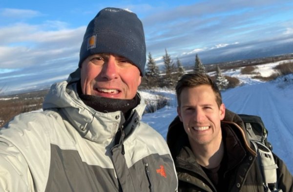 Faculty member Shawn Bultsma and graduate Joseph Hausler smile for a photo overlooking Kachemak Bay in Alaska.