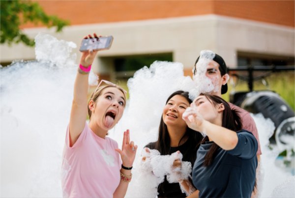 Students pose for a selfie while playing in a foam pit during Laker Kickoff August 22. 