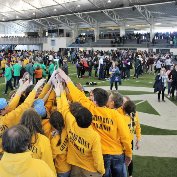 Grand Haven High School team members celebrate winning the Division C Tournament.