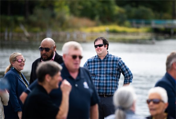 A man mingles with a crowd of people. 