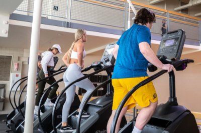 people working out in the Rec Center on stair climbers, without masks