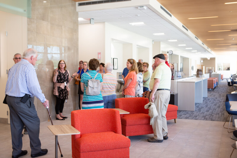 group of people listening to one woman talk