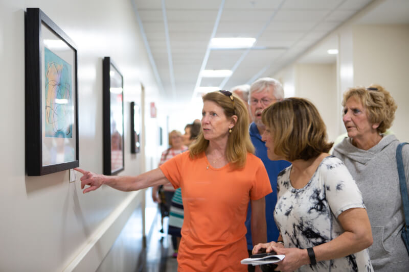 people looking at artwork