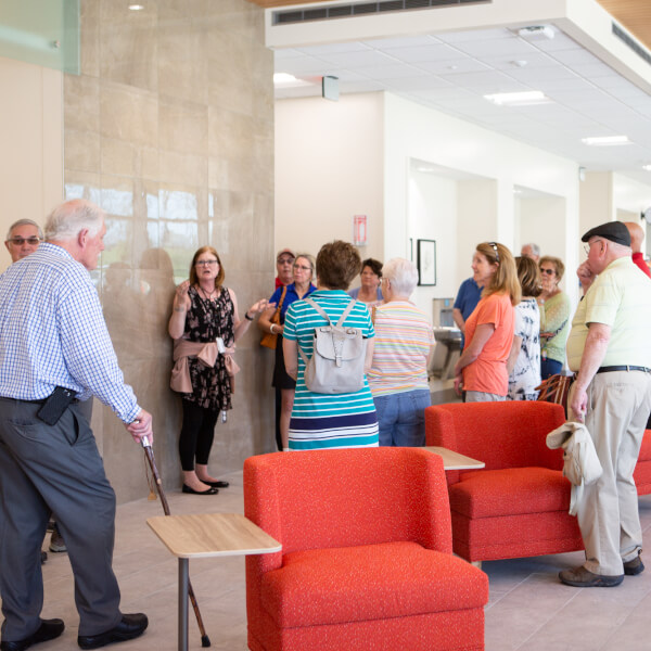 group of people listening to one woman talk