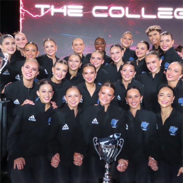 the Laker Dance Team on stage with two national trophies