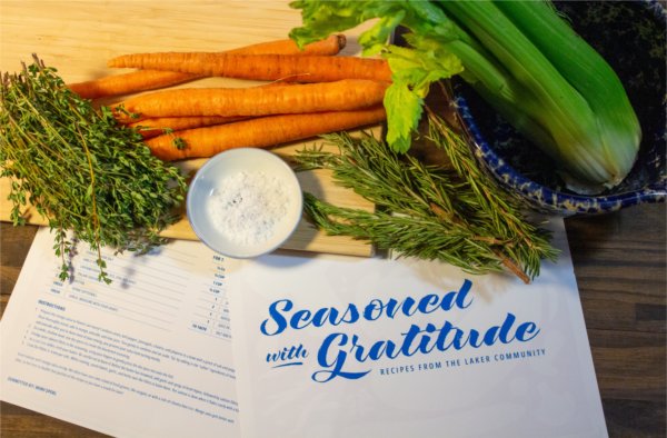 Seasoned with Gratitude recipe card and recipe near fresh carrots, dill and celery needed for that recipe