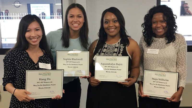four women holding certificates