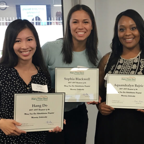 four women holding certificates