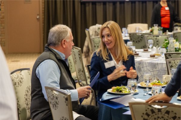 Ingrid Tighe speaks with an attendee at the Veterans Day Luncheon